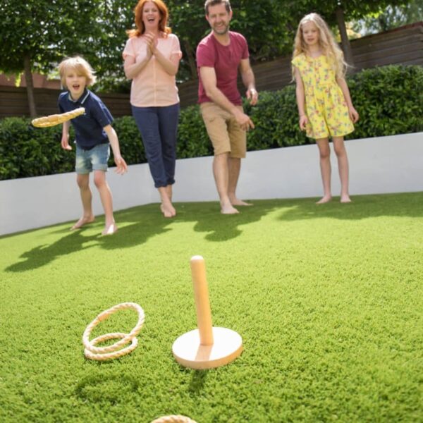 Family playing lawn games on artificial grass